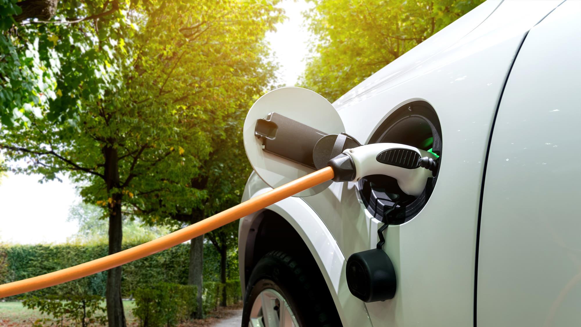 A photo depicting an electric car being charged.