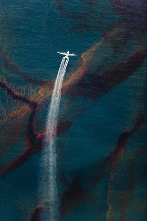 A C-130 plane spraying dispersant at the Deepwater Horizon oil spill in the Gulf of Mexico, May 2010.