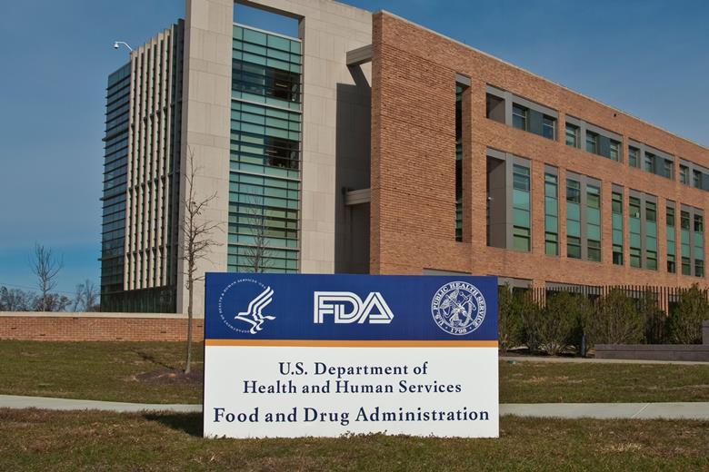 FDA Building 21 stands behind the sign at the FDA campus main entrance and houses the Center for Drug Evaluation and Research.